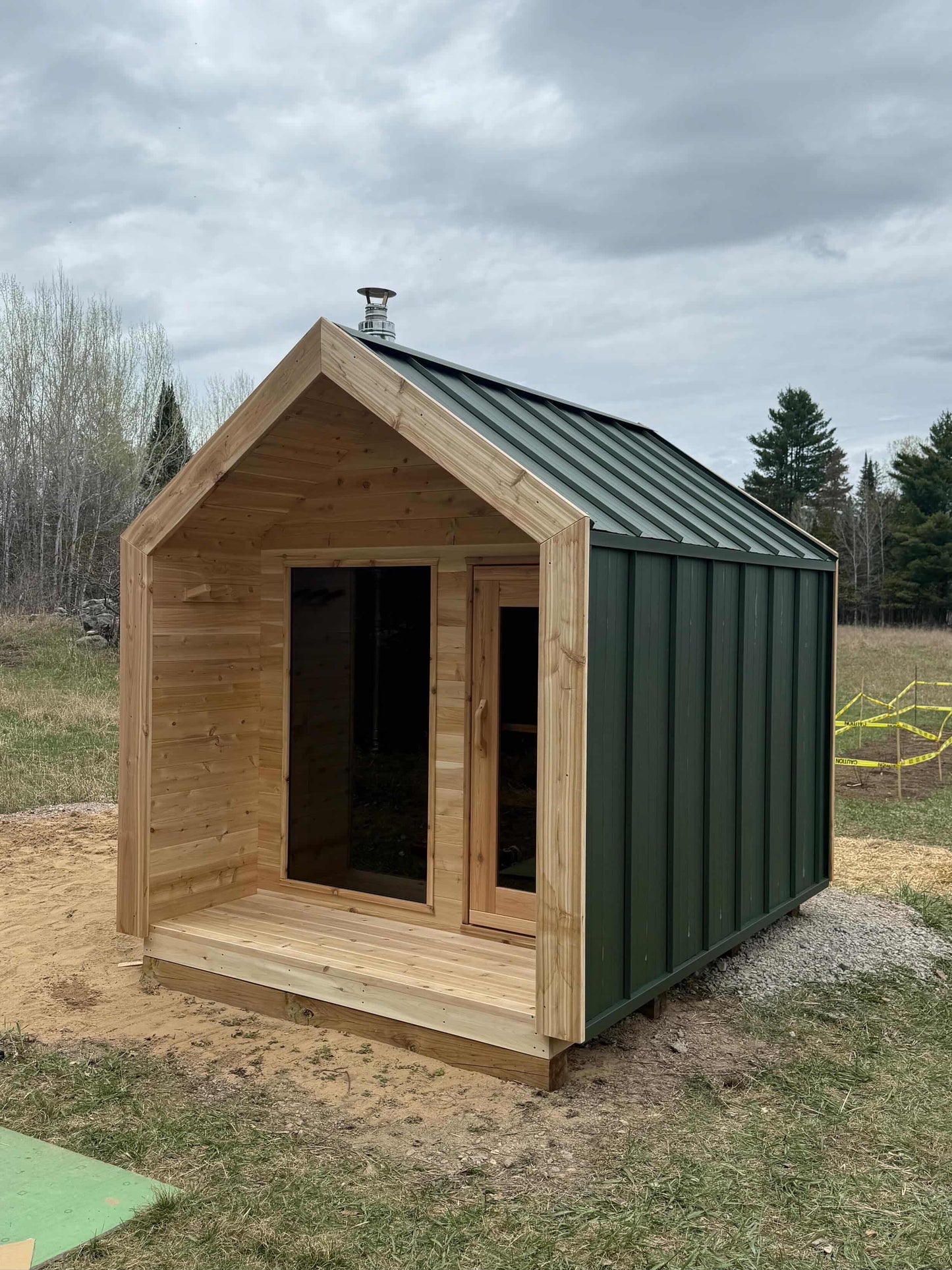 Modern Cabin Sauna with Steel Roof and Siding with 2 Front Windows